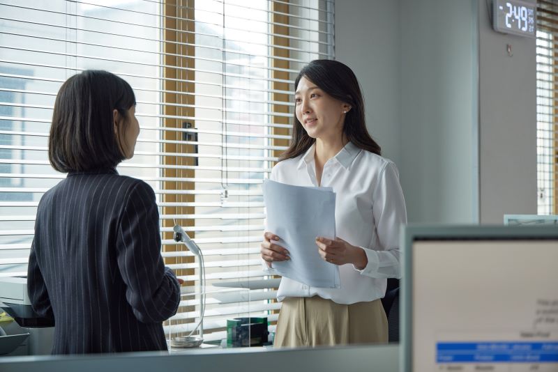 Acidente de trabalho e estabilidade​: funcionária conversando com sua gestora no escritório.